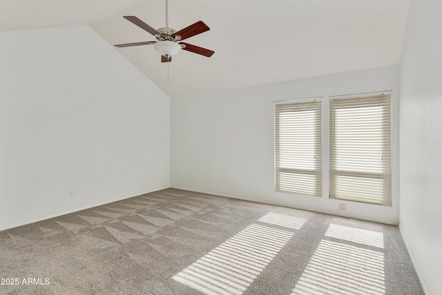 carpeted empty room with high vaulted ceiling and ceiling fan