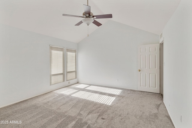 spare room featuring light colored carpet, high vaulted ceiling, and ceiling fan