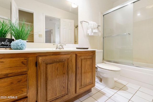 full bathroom featuring tile patterned flooring, vanity, combined bath / shower with glass door, and toilet