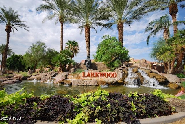 community sign with a garden pond