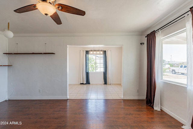 spare room featuring light hardwood / wood-style flooring, ceiling fan, and crown molding