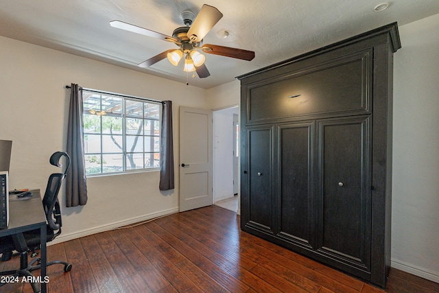 office with dark hardwood / wood-style floors and ceiling fan