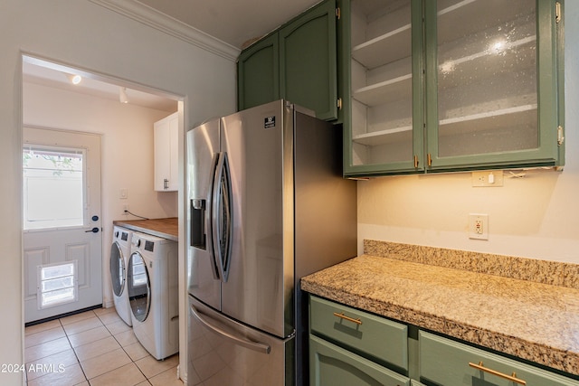 kitchen with washing machine and dryer, ornamental molding, stainless steel refrigerator with ice dispenser, and green cabinetry