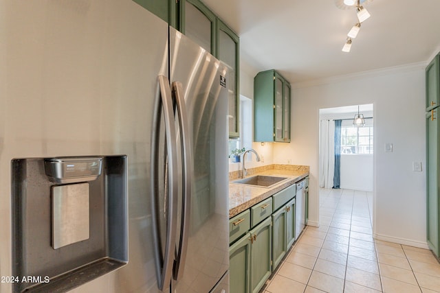 kitchen with stainless steel fridge, light tile patterned floors, green cabinets, and sink