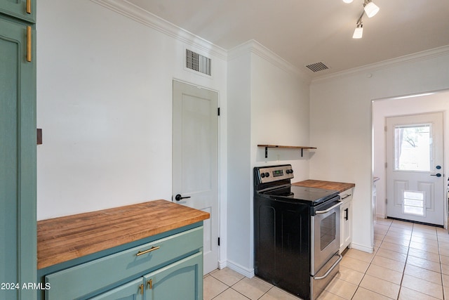 kitchen with electric range, light tile patterned floors, ornamental molding, and wooden counters