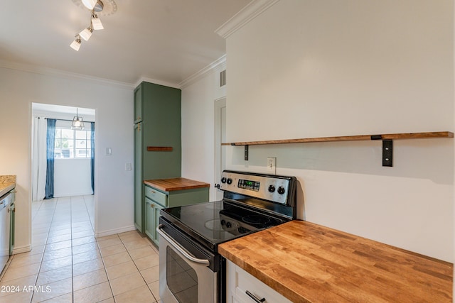 kitchen featuring wood counters, green cabinets, crown molding, light tile patterned floors, and appliances with stainless steel finishes