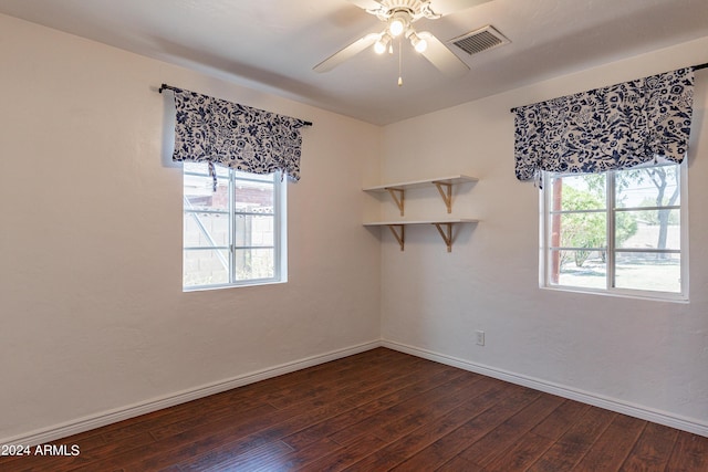 empty room featuring ceiling fan and dark hardwood / wood-style flooring