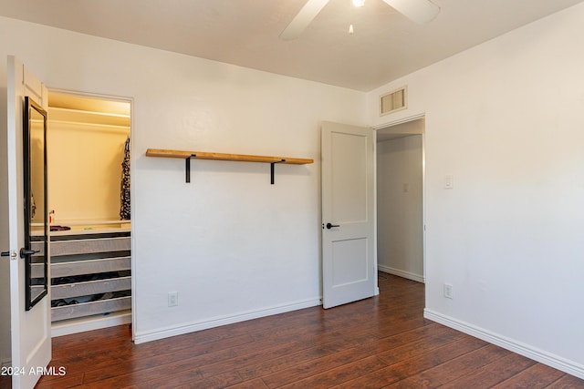 unfurnished bedroom featuring dark hardwood / wood-style flooring and ceiling fan