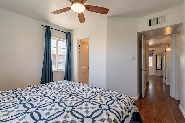 bedroom featuring ceiling fan and dark wood-type flooring