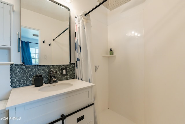 bathroom with decorative backsplash, a shower with curtain, and vanity