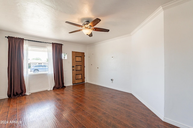 unfurnished room with ceiling fan, crown molding, and dark wood-type flooring