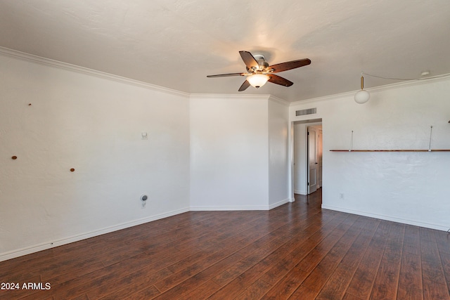 empty room with ceiling fan, dark wood-type flooring, and ornamental molding