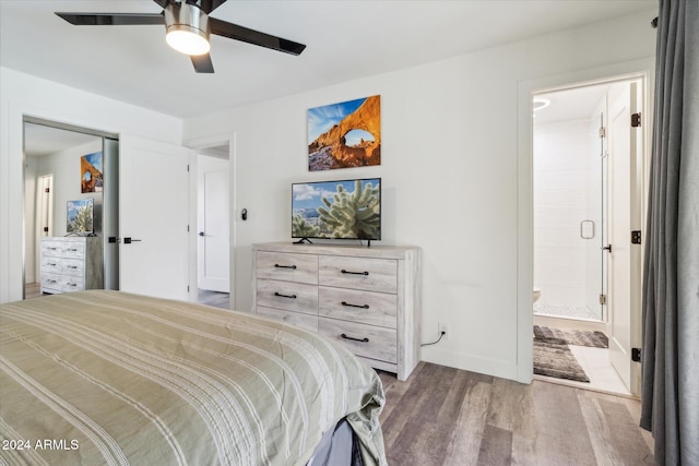 bedroom featuring connected bathroom, ceiling fan, and wood-type flooring