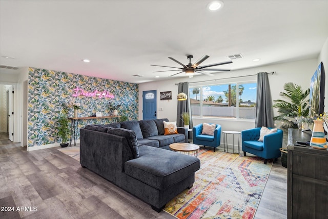 living room featuring ceiling fan and hardwood / wood-style floors