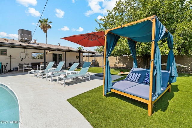 view of swimming pool with a patio, a yard, and central air condition unit