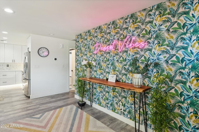 hallway with light hardwood / wood-style floors