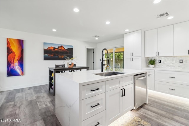 kitchen with sink, dishwasher, white cabinets, and a kitchen island with sink