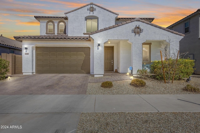 mediterranean / spanish-style house with a garage