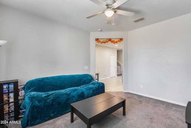 living room with light colored carpet and ceiling fan