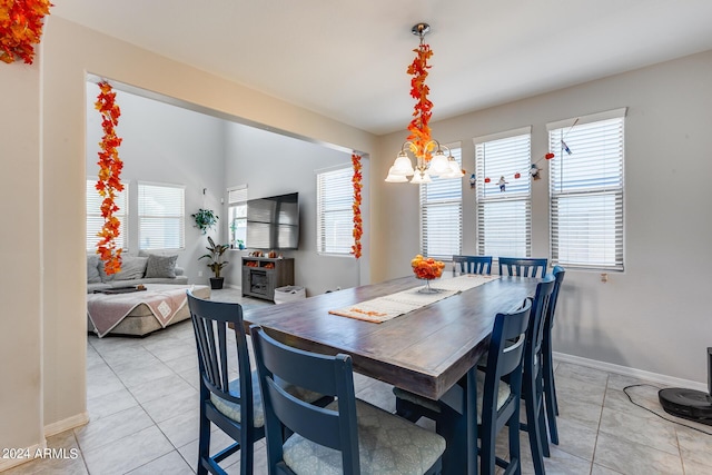 dining room with an inviting chandelier and light tile patterned floors