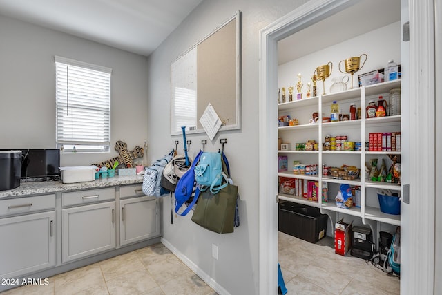 laundry room featuring light tile patterned flooring