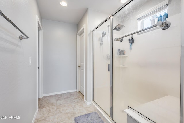 bathroom with a shower with door