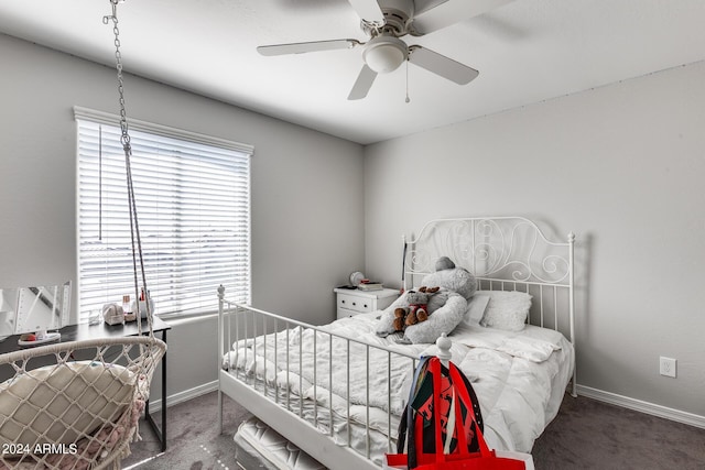 carpeted bedroom featuring ceiling fan and multiple windows