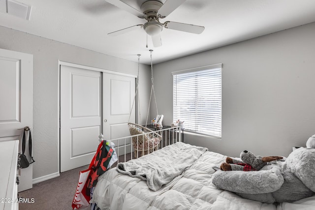 bedroom with carpet, ceiling fan, and a closet