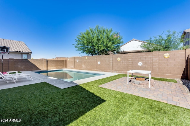 view of pool featuring a lawn and a patio