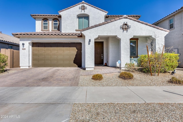 mediterranean / spanish house with a garage