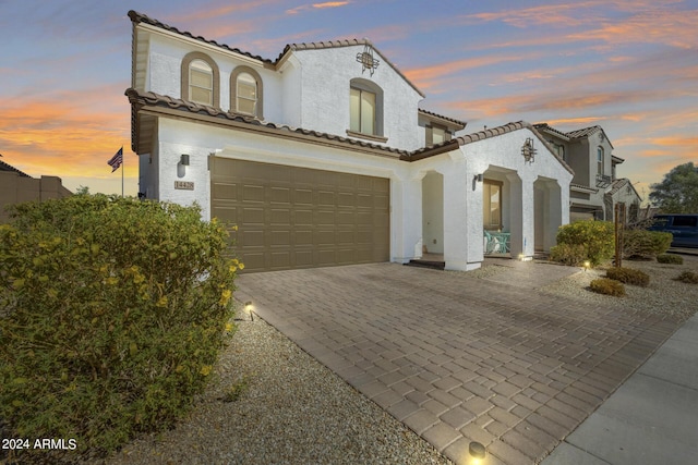 mediterranean / spanish home featuring a garage