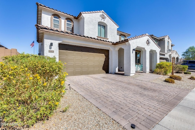 mediterranean / spanish home featuring a garage