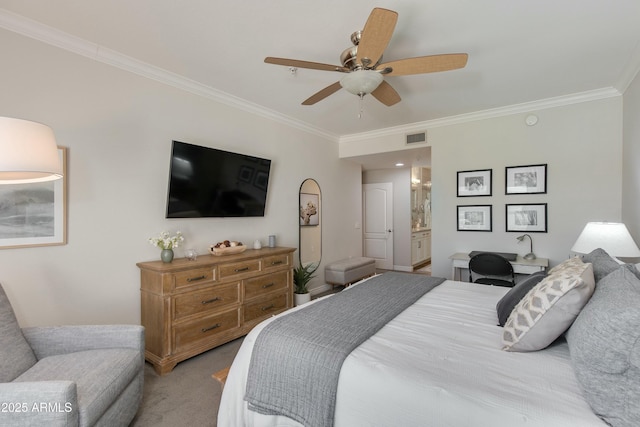 bedroom with ensuite bath, ornamental molding, ceiling fan, and carpet