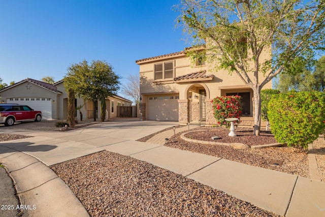 mediterranean / spanish home featuring stucco siding, stone siding, driveway, and a tile roof