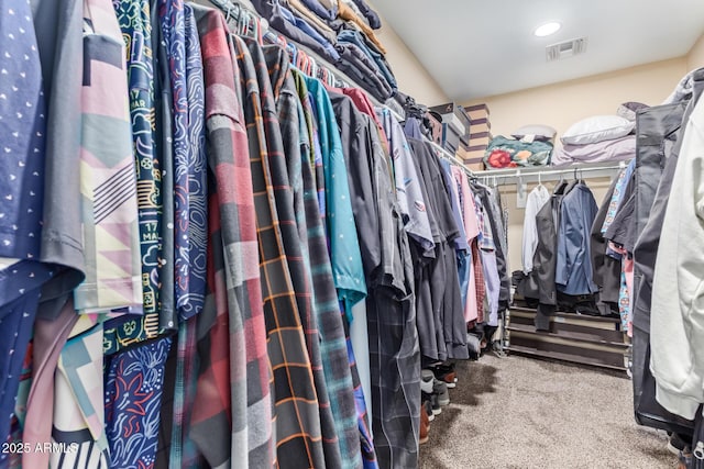 walk in closet featuring visible vents and carpet floors