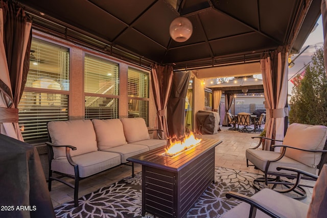 view of patio / terrace featuring a gazebo, outdoor dining area, and an outdoor living space with a fire pit