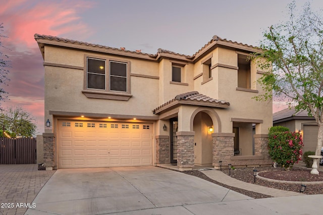 mediterranean / spanish home with stucco siding, driveway, and a garage