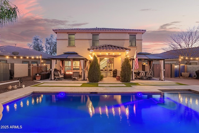 outdoor pool featuring a gazebo, a patio area, fence, and an outdoor living space