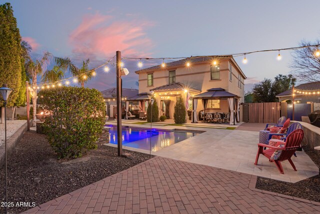 view of pool with a gazebo, a fenced in pool, a patio area, and fence