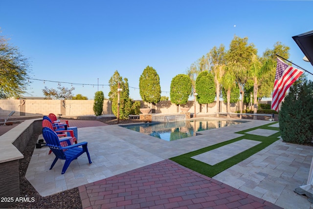 view of swimming pool featuring a patio area, a fenced in pool, and a fenced backyard