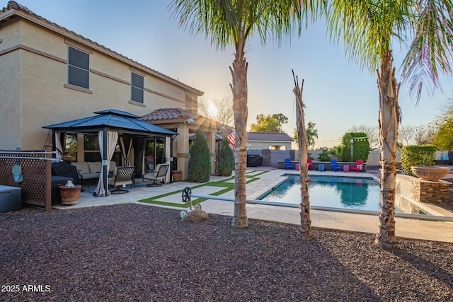 view of swimming pool featuring a patio, fence, a gazebo, outdoor lounge area, and a fenced in pool