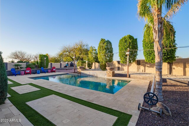 view of swimming pool featuring a patio area, a fenced backyard, and a fenced in pool