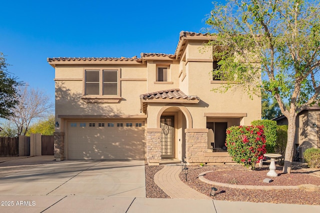 mediterranean / spanish-style home featuring concrete driveway, a garage, stone siding, and stucco siding