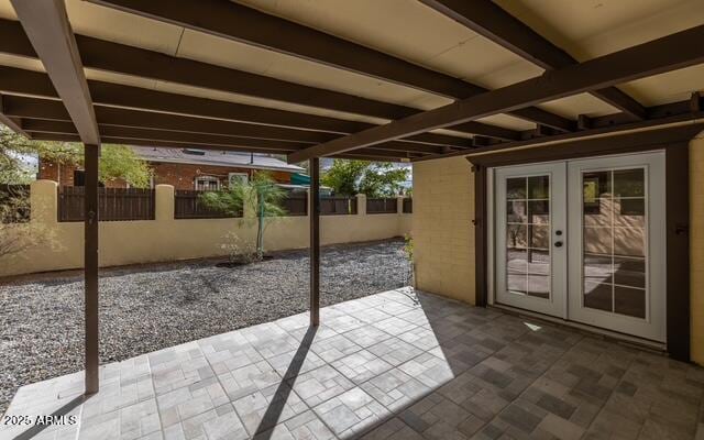 view of patio featuring fence and french doors
