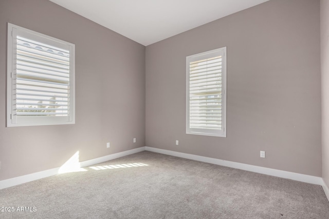 spare room featuring light colored carpet