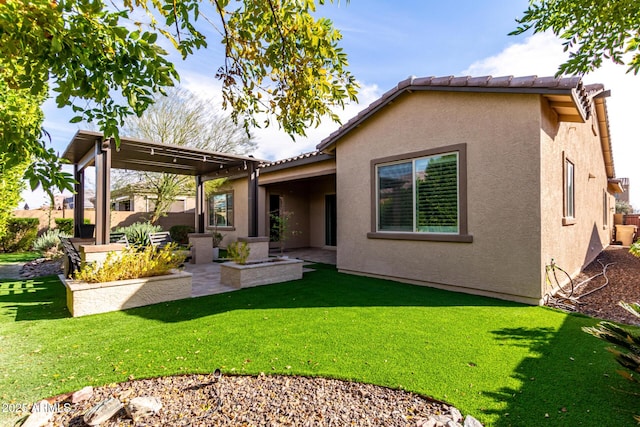 rear view of house featuring a patio and a lawn