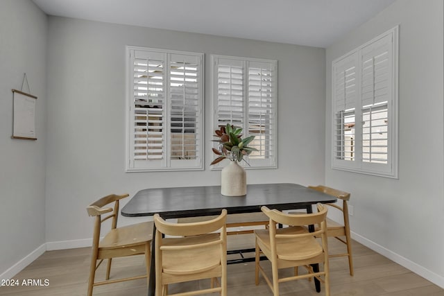 dining space featuring light wood-type flooring