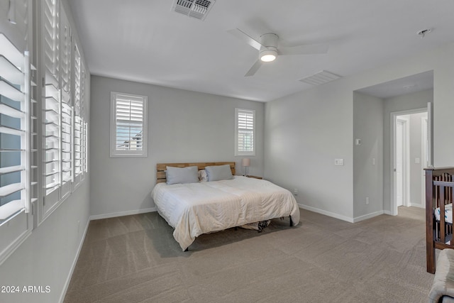 bedroom with ceiling fan and light colored carpet