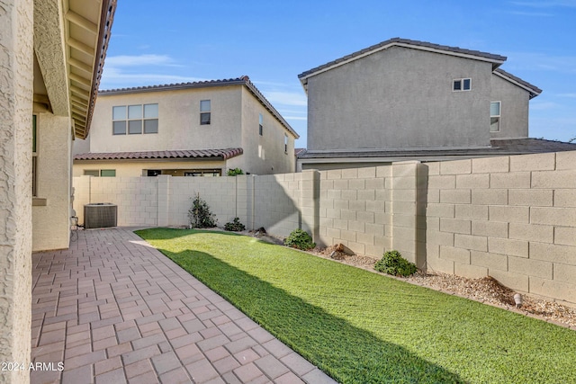 view of yard featuring central AC unit and a patio area