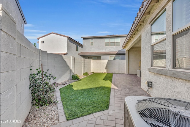 view of yard with cooling unit and a patio area